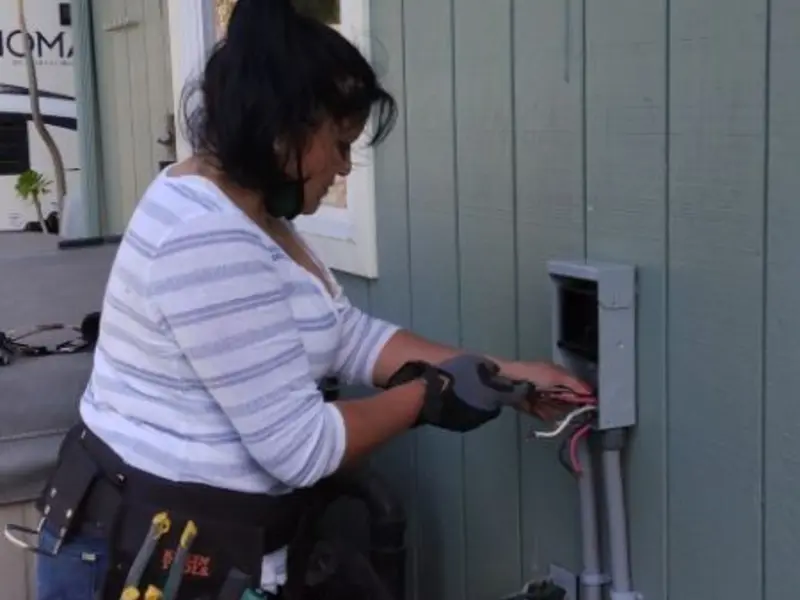 Licensed electrician wiring an exterior subpanel in Branford
